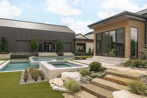 Pool courtyard at Harper Landing in Fairview, Texas surrounded by modern architecture and landscaped lawn.