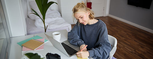 portrait-smiling-young-woman-female-student-doing-distance-learning-course-using-laptop-st