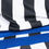 Thumbnail: Close up of fabric showing black and white stripes and blue waist band.