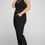 Thumbnail: Woman standing in black pant set.
