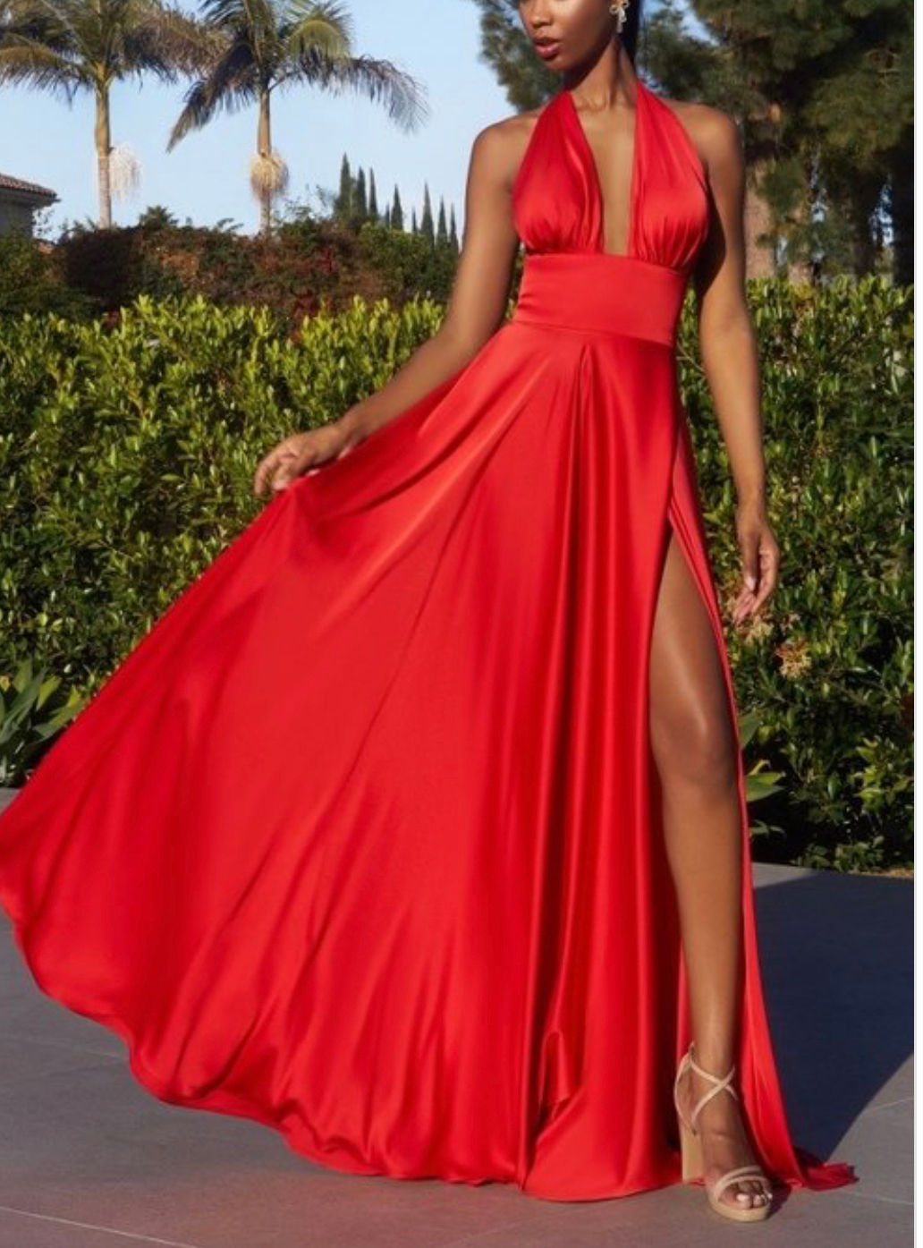 Woman in flowing red halter gown.
