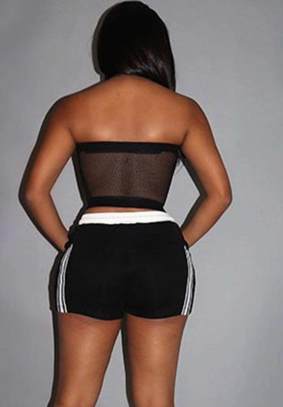 Thumbnail: Woman in black short with white trim set.