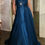 Thumbnail: Woman in rich blue flowing gown.