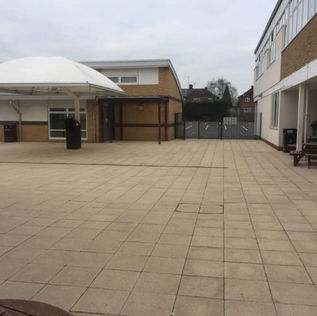 A clean, wide paved courtyard area outside a building facility