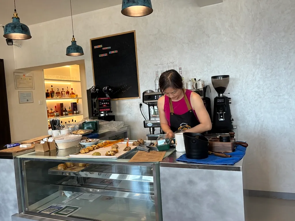 Xiao is packing up cookies for customers. Tim's freshly baked, half-sugar cookies are a big hit every day. (Photo by Joyce)
