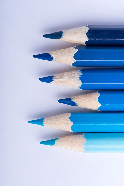 Macro photograph of several sharpened pencils of blue color on a white background_edited_e