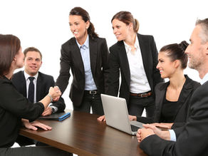 Business women at a meeting shaking hands