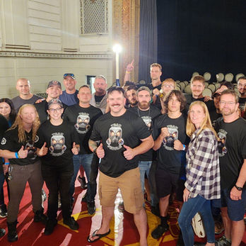 wide angle group photo with black branded shirts on