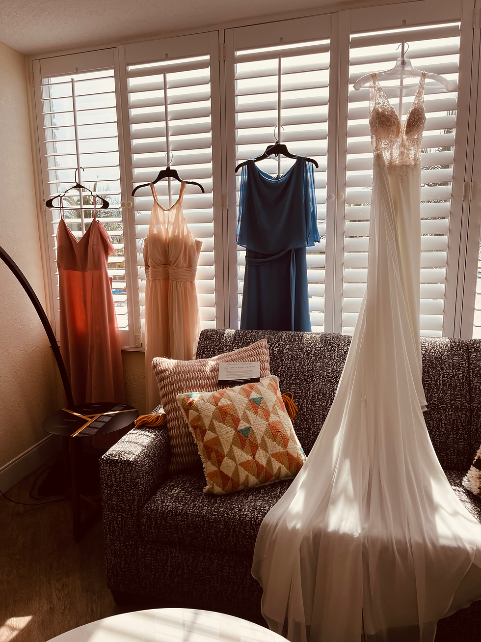 White wedding dress and colorful gowns ready for luxury garment care