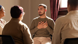 A person speaking at a meeting