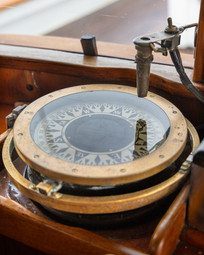 brass compass in the wheelhouse of the Passing Cloud