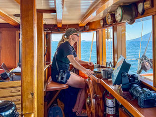Crew aboard Passing Cloud sailing through remote channels near Princess Royal Island
