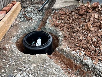 Attgills Drainage Services - Annex Drainage Northamptonshire - Installation of underground drainage pumping station chamber with pipework trenches during annex drainage works.