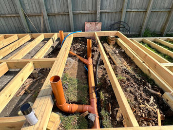 Attgills Drainage Services - Annex Drainage Northamptonshire - New underground PVC drainage system installed within annex timber foundation, including vertical waste pipe connections.