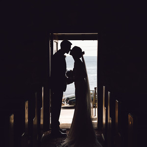 Bride and groom kiss in the Wilson Memorial Chapel in Maine.