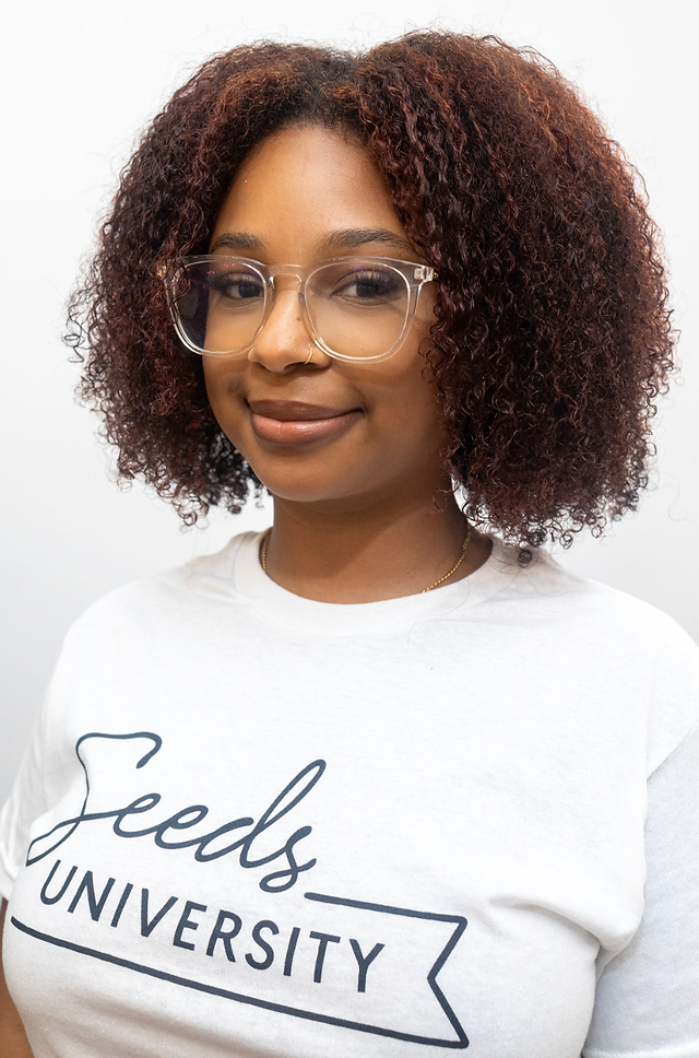 young black girl with clear glasses and ginger red curly natural afro hair
