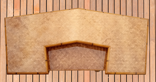 down view of a custom made bamboo tiki bar with a natural fiber bamboo bar top encased in epoxy resin