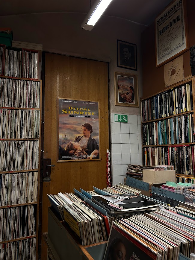 A Before Sunrise movie poster hangs on the door of the listening booth in this record store. Alt & Neu Record store in Vienna, Austria. This is the record store that Jesse and Celine visited in Before Sunrise.