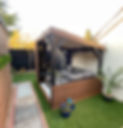 Bespoke pergola outdoor structure with seating and log burner in a garden in Sandy