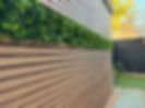 Slatted panelled wall with folliage in a residential garden in Bedfordshire