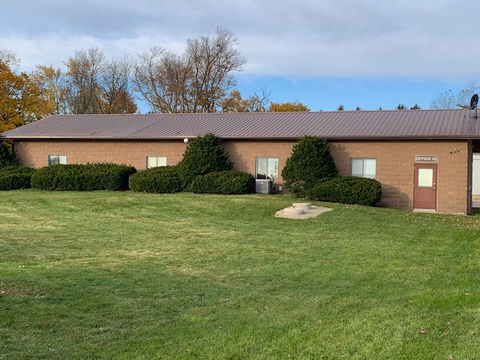 Wildwood office, green grass, blue sky with clouds
