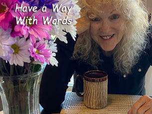 Picture of person setting playing scrabble with a bouquet of flowers and a cup of coffee. Words on image say Have a way with words - Sheri & Bill