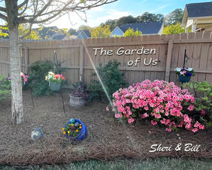 Image of backyard flower garden. Text on image says The Garden of Us (original photography by Sheri & Bill)