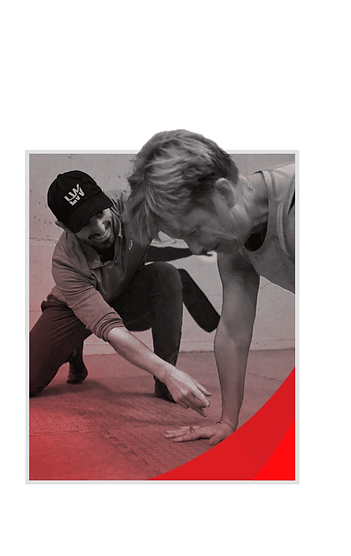 Coach Helping Member With Plank Form