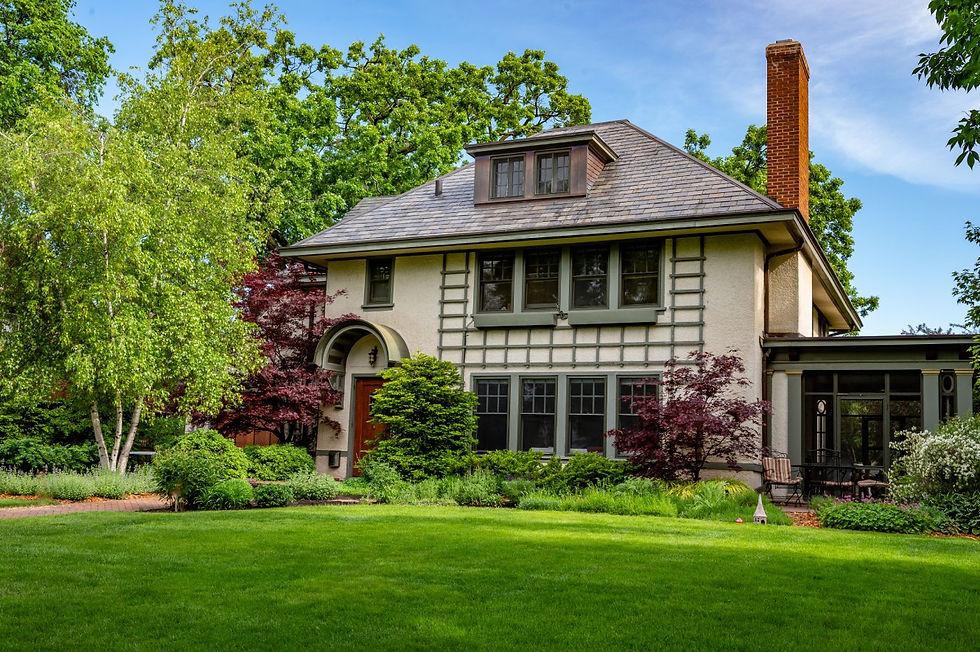 Large historic two-story home with mature trees, manicured lawn, and landscaped front yard, representative of residential properties involved in estate appraisal work in western Wisconsin and eastern Minnesota.