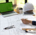 Top view, Architect or engineer hands working on blueprint plans with a pencil and laptopa ruler, calculator, and engineering tools. Woman architect or engineer working on blueprint in office.