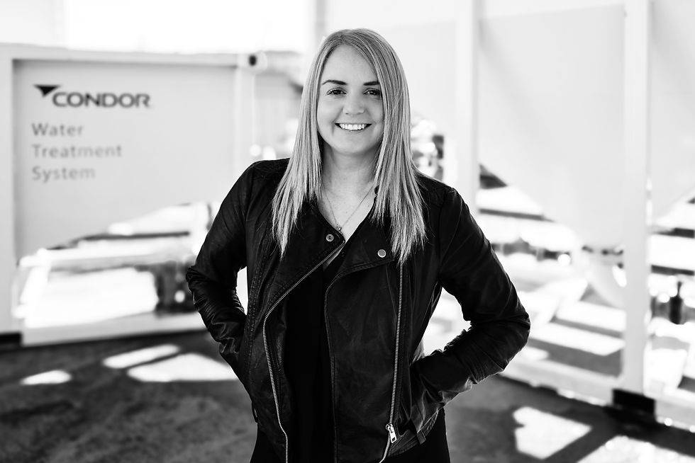 Two construction men talking next to Condor Civil's Water Treatment System