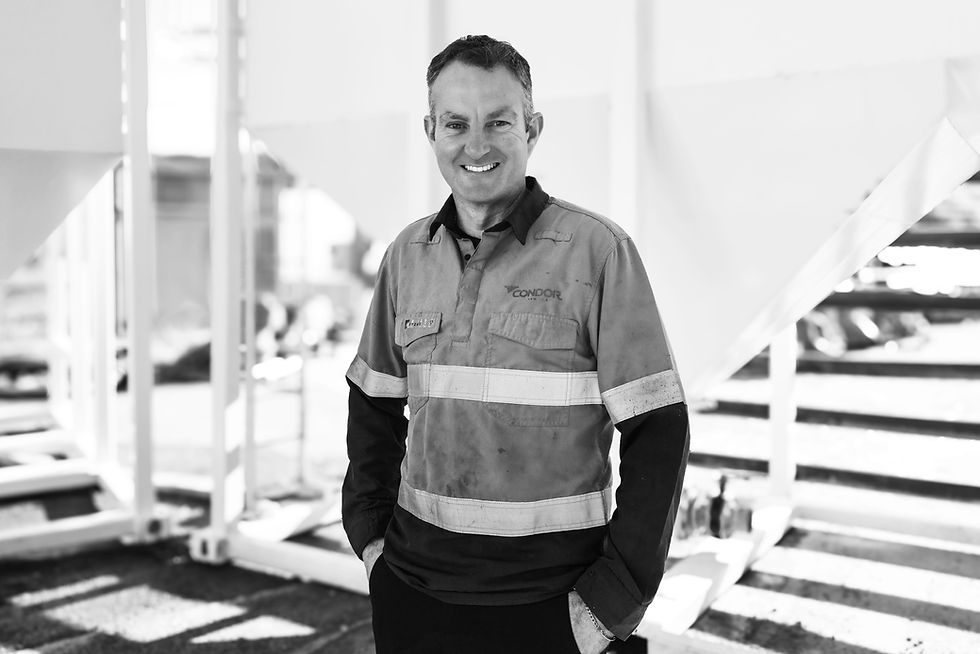Two construction men talking next to Condor Civil's Water Treatment System