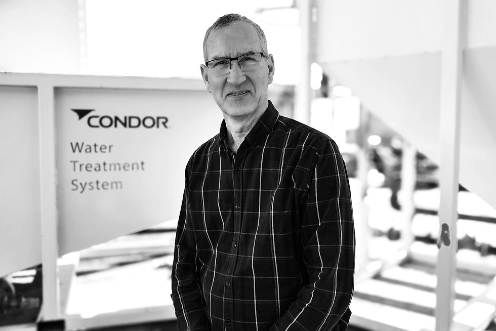 Two construction men talking next to Condor Civil's Water Treatment System