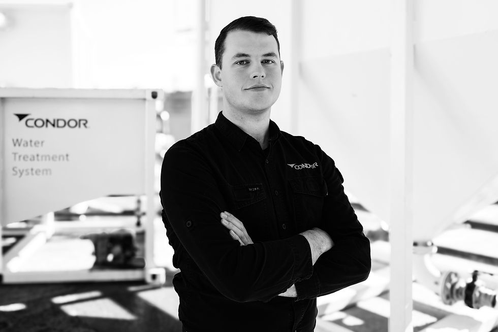Two construction men talking next to Condor Civil's Water Treatment System