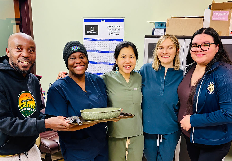 Clinic staff standing together in the nursing station.