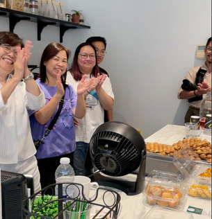 Volunteers and guests clap in appreciation, likely for performances or the efforts of the team.