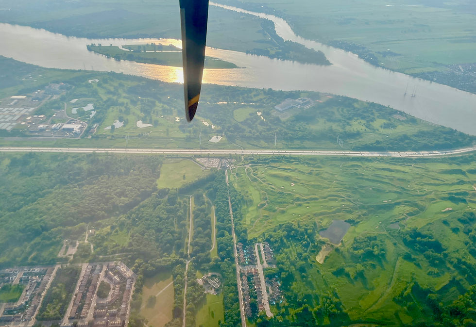 Aerial view of the St. Lawrence River and green landscapes near Montreal, seen from an Air Creebec plane en route from Chisasibi.