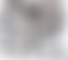 Collection of traditional Rwandan woven baskets in black and white geometric patterns displayed on a wall