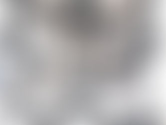 Collection of traditional Rwandan woven baskets in black and white geometric patterns displayed on a wall