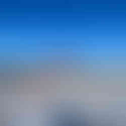 A stop sign on a snowy road next to a painted barrel that reads “We Care,” with a person’s shadow visible in the foreground.