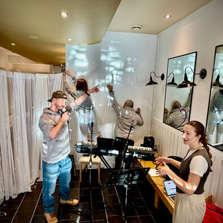 olunteers setting up and rehearsing music inside the café space before CommunauThé