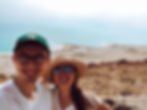 boy and girl in hats taking selfie in front of dead sea israel scenery