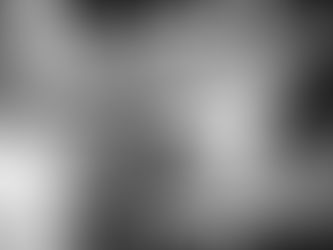 Black and white photo of multiple hands stacked together, symbolising unity, trust and collaboration.