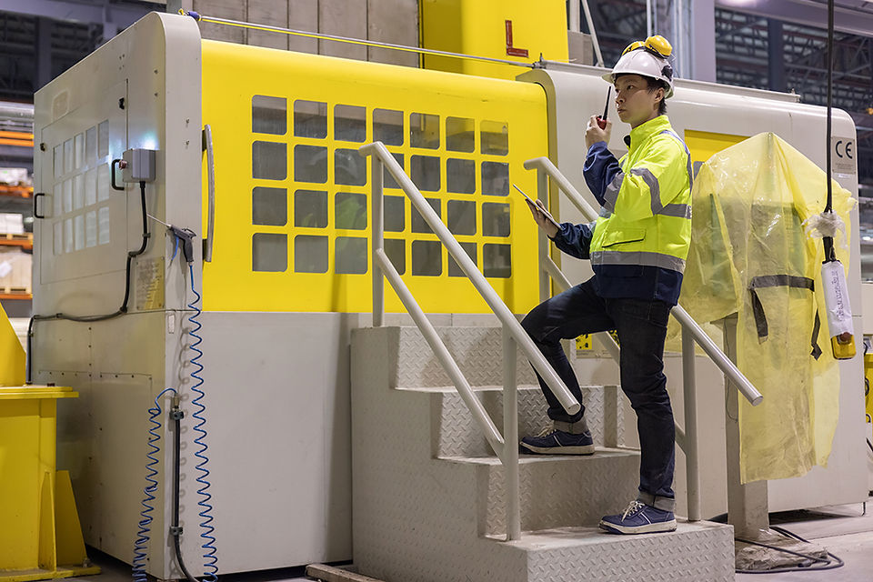 man standing on concrete stairs in factory