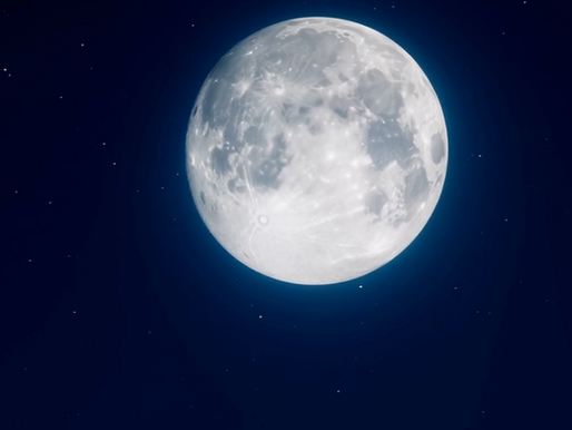 Full moon glowing softly in a dark blue night sky with small stars scattered around it.