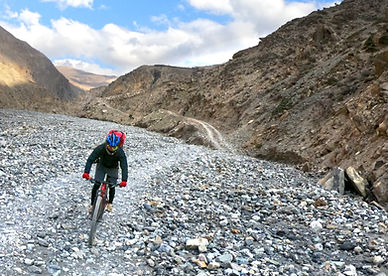 Mountain bike riding up stone trail, Uperr Mutang, Nepal
