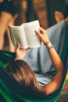 Woman reading book on hammock