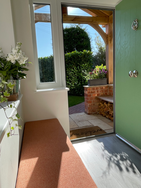 Green painted Farrow & Ball bootroom with fitted seating and pull-out drawers, designed and installed by Woodwork Interiors in Knutsford, Cheshire.
