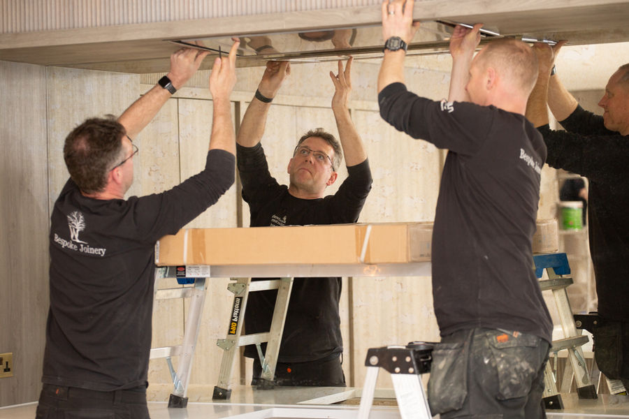 Woodwork Interiors installation team fitting custom kitchen cabinetry in Knutsford