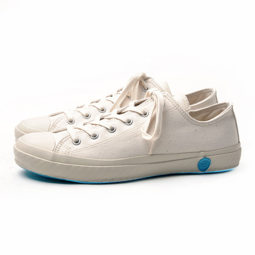 Best Shoes to Buy in Japan in 2026: 10 Japanese Brands Worth Shopping 5 White Shoes Like Pottery canvas low-top sneakers with rubber toe caps and distinctive blue circular seals